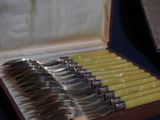 a box with a set of silver spoons in it