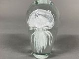 a glass vase that has a jelly inside of it
