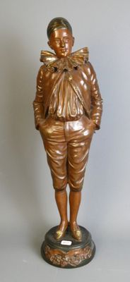 bronze statue of a boy with a bow on his head