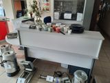 a kitchen counter with a lot of dishes on it
