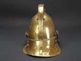an antique brass helmet with a metal band around the neck