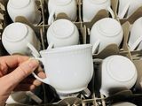 a person that is holding a cup in a dishwasher