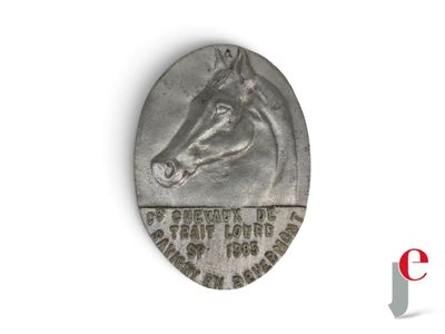 an old silver coin with a horse head on top of it