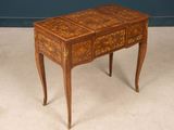 a small wooden table with a drawer on it
