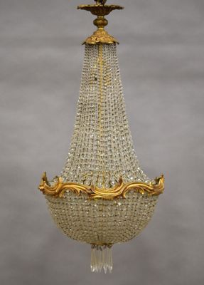 a gold and crystal chandelier hanging from a ceiling