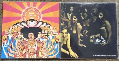 two cd ' s of jimi hendrix and the jimi hendrixs on a carpet