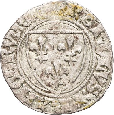 a silver coin with a shield on the reverse side