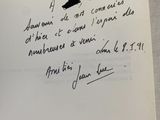 an open book with a handwritten poem on it sitting on a table