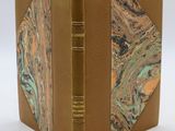 an open book with a marbled cover on a white surface