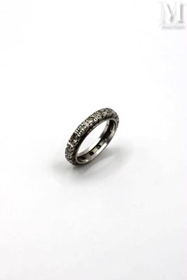a close up of a ring with black diamonds on a white background