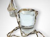 a glass of water with a chain around it and a vase with flowers in it