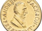 a close up of a gold coin with a man ' s face on it
