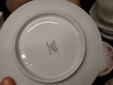 a person holding a white plate with a black writing on it