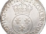 a silver coin with a crown on top of it