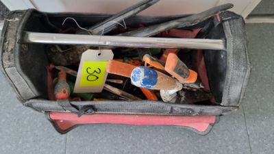 a bag full of tools sitting on the floor