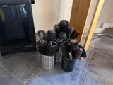 a lot of hair brushes in a cup on the floor