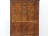 an old wooden cabinet with a marble top on a white floor