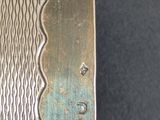 a close up of a metal object on a black surface