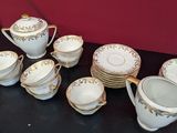 a table with a bunch of cups and saucers on it