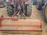 a tractor with a plow attached to the front of it