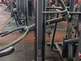 a gym with a row of machines in the middle of the room
