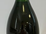 Des bouteilles de vin sont alignées sur une surface blanche