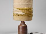 the table lamp is made of wood and has a brown base