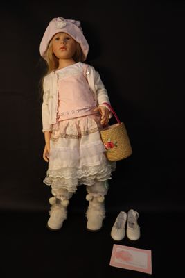 a doll that is standing next to a basket and shoes
