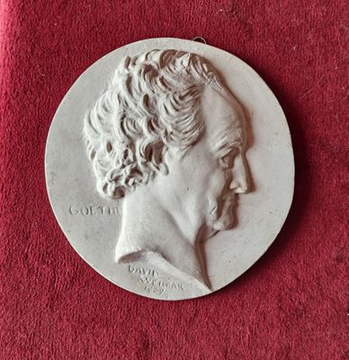 an image of a silver medal with a man ' s face on it