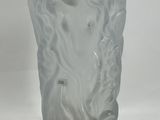 a close up of a frosted glass vase on a white surface