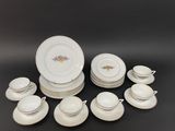 many plates and cups and saucers on the table