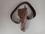 a brown leather holster on a white table