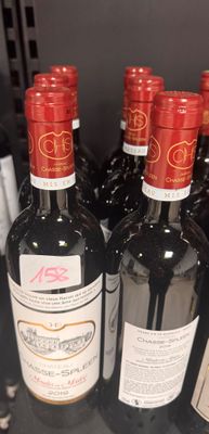 several bottles of wine are lined up on a table