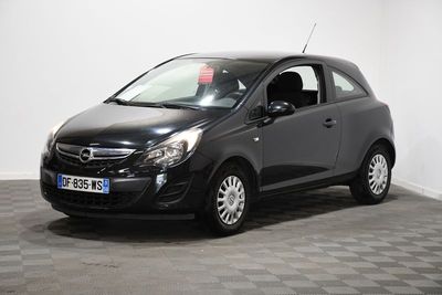 a black opel parked in a room with a checkered floor