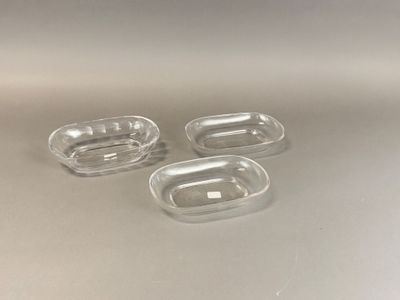 three clear plastic containers sitting on top of a white surface
