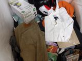 a pile of clothes and other items in a suitcase