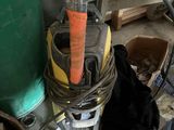 a picture of a cluttered garage with tools on the floor