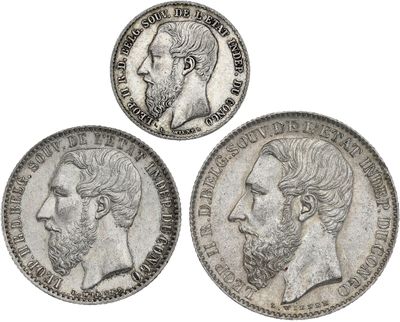three silver coins with a man and a woman on them