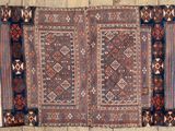 an old rug on a wooden floor with a lot of different colors