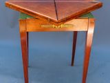 an image of a small wooden table with a green cloth on top