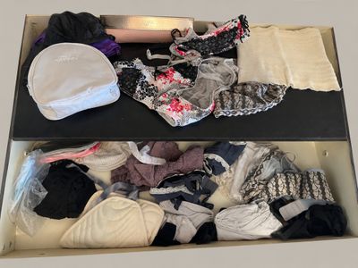 a box full of underwear and a hat on a table