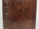 an old leather book with gold trimmings on a white background