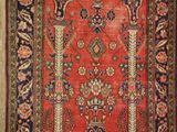 a red and blue rug with a floral design on it