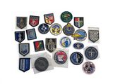 a lot of military patches on a white surface