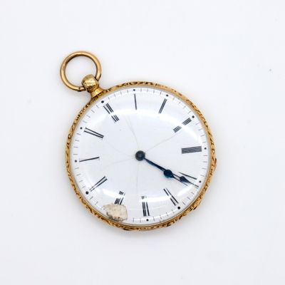 a gold pocket watch with roman numerals on the face
