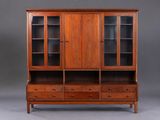 a large wooden cabinet with glass doors and drawers