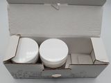 a box with two containers in it on a white surface