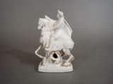a statue of a man riding a horse with a bird on its back