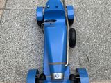 a blue toy car that is sitting on the ground