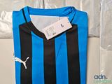 a blue and black striped shirt with a tag on it